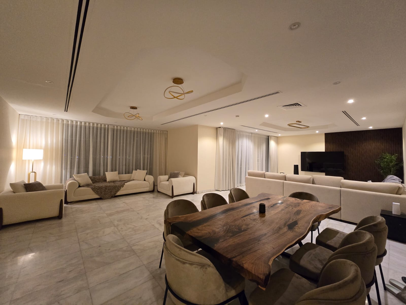 open-plan living room with custom seating and tailored window treatments