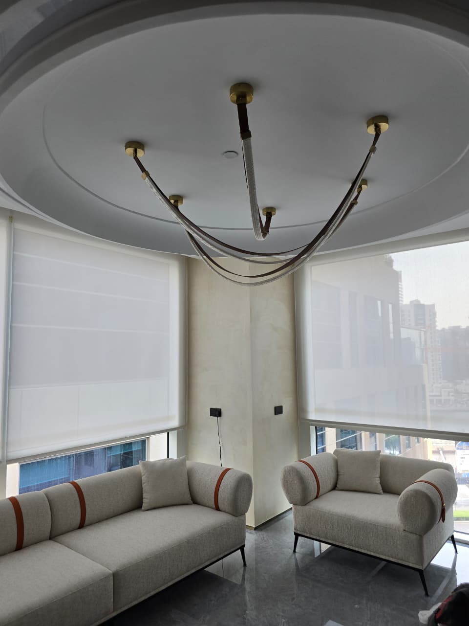 roller blinds installed across a corner of floor-to-ceiling glazing