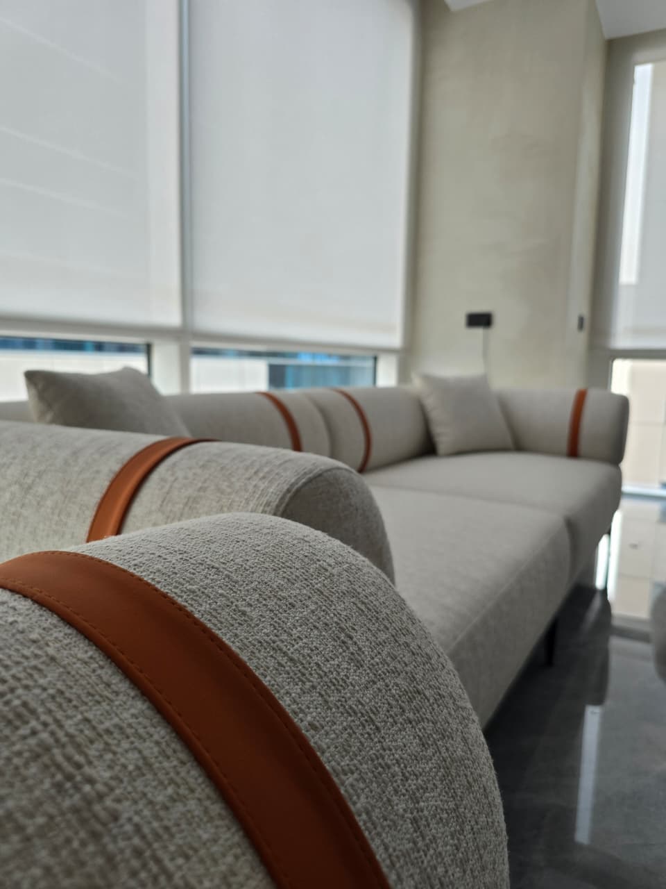 close-up of upholstered seating with fabric grain and leather trim detail