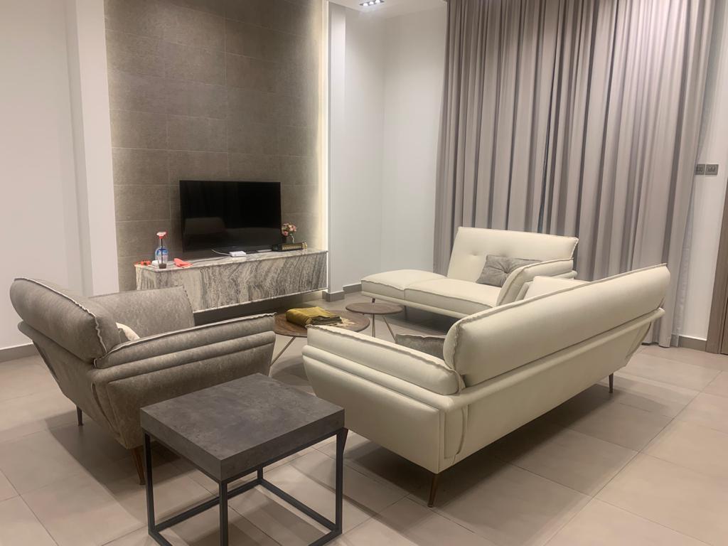 open-plan living and dining room with custom lounge seating and full-height curtains