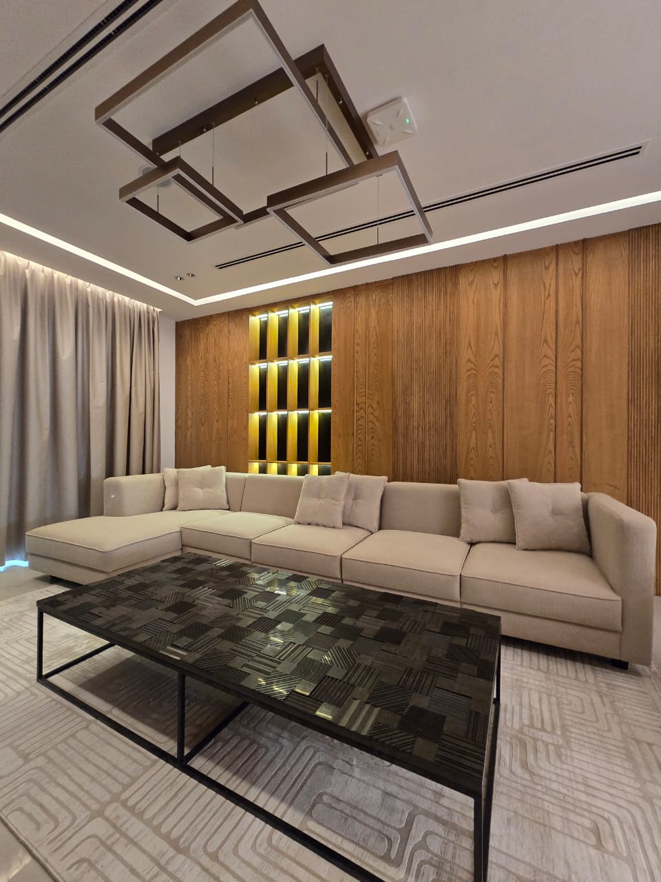 custom sectional lounge set against a timber feature wall
